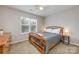 A comfortable bedroom boasts a cozy queen bed, a bright window, and a dark dresser with wood accents at 2614 Ocracoke St, Charlotte, NC 28208