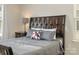 Close-up shot of the bed in the bedroom, complete with accent pillows and a side table at 2614 Ocracoke St, Charlotte, NC 28208