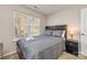 Comfortable bedroom features a cozy queen bed, bright window, wood headboard and bedside table, neutral carpet at 2614 Ocracoke St, Charlotte, NC 28208