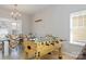 Dining area features foosball table, glass dining table with six chairs, tile flooring and a chandelier at 2614 Ocracoke St, Charlotte, NC 28208