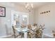The dining area has a glass table, stylish chairs, decorative lighting and access to the outdoors at 2614 Ocracoke St, Charlotte, NC 28208