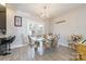 Dining space featuring a glass dining table with six upholstered chairs and an elegant chandelier at 2614 Ocracoke St, Charlotte, NC 28208