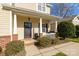 Welcoming front porch with brick accents, manicured landscaping, and a charming entryway to the home at 2614 Ocracoke St, Charlotte, NC 28208