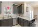 Kitchen with granite countertops, stainless steel dishwasher, and dark cabinets at 2614 Ocracoke St, Charlotte, NC 28208