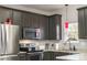 Updated kitchen featuring stainless steel appliances, granite countertops, tile backsplash and modern fixtures at 2614 Ocracoke St, Charlotte, NC 28208