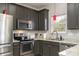Well-equipped kitchen featuring stainless steel appliances, granite countertops and dark wood cabinets at 2614 Ocracoke St, Charlotte, NC 28208