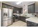 Modern kitchen featuring stainless appliances, tile floors, and granite countertops at 2614 Ocracoke St, Charlotte, NC 28208