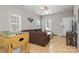 The living room showcases hardwood floors, a ceiling fan, a sectional sofa and a foosball table at 2614 Ocracoke St, Charlotte, NC 28208