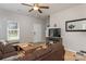 Cozy living room featuring a comfortable sectional sofa, ceiling fan and lots of natural light at 2614 Ocracoke St, Charlotte, NC 28208