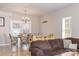 Bright living room with open layout, a comfortable sofa, adjacent dining area, and tile flooring at 2614 Ocracoke St, Charlotte, NC 28208
