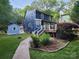 Backyard view featuring a well-maintained lawn, a deck with white railing, and a storage shed at 27092 Village Dr, Fort Mill, SC 29708