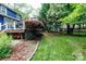 Backyard landscaping and lawn with deck attached to house in background at 27092 Village Dr, Fort Mill, SC 29708