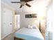 Cozy bedroom featuring a modern ceiling fan and a light blue comforter on a bed frame at 27092 Village Dr, Fort Mill, SC 29708