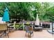 Back deck featuring multiple seating areas and surrounded by mature trees at 27092 Village Dr, Fort Mill, SC 29708