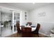 Charming dining area with wood flooring, stylish lighting, and an adjacent sunroom at 27092 Village Dr, Fort Mill, SC 29708