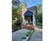Charming blue home features a stone chimney and inviting front porch with brick steps and walkway at 27092 Village Dr, Fort Mill, SC 29708