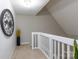 Upstairs hallway featuring neutral carpet and white railings at 27092 Village Dr, Fort Mill, SC 29708