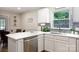 Bright kitchen features a quartz countertop, mosaic backsplash, stainless appliances, and an undermount sink at 27092 Village Dr, Fort Mill, SC 29708