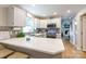 Bright kitchen features a quartz countertop, mosaic backsplash, stainless appliances, and an inviting eat-in bar at 27092 Village Dr, Fort Mill, SC 29708