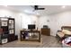 Home office featuring wood floors, ceiling fan, neutral walls, and ample natural light at 27092 Village Dr, Fort Mill, SC 29708
