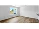 A bright and spacious bedroom with light wood-look flooring and a large window at 3136 Ora Smith Rd, Lincolnton, NC 28092