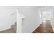 Bright entryway with wood-look flooring, white trim, and a carpeted staircase at 3136 Ora Smith Rd, Lincolnton, NC 28092