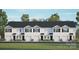 New construction townhome with a white facade, a row of garages, and a lush green lawn at 3136 Ora Smith Rd, Lincolnton, NC 28092