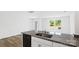 Kitchen featuring a granite countertop, black dishwasher, and wood-look flooring at 3136 Ora Smith Rd, Lincolnton, NC 28092