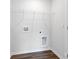 A tidy laundry area features wood-look flooring and connections for a washer and dryer at 3136 Ora Smith Rd, Lincolnton, NC 28092