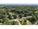 Expansive aerial view of a lush, wooded community with single-Gathering homes nestled among mature trees at 321 E Taylor St, Landis, NC 28088