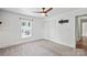 Neutral bedroom features plush carpeting, a ceiling fan, and large windows, providing a serene and inviting space at 321 E Taylor St, Landis, NC 28088