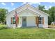 Charming home exterior with manicured lawn, American flag, and inviting front porch at 321 E Taylor St, Landis, NC 28088