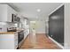 Bright kitchen boasts stainless appliances, wood countertops, and white cabinetry with hardwood flooring and modern finishes at 321 E Taylor St, Landis, NC 28088