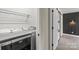 Laundry area features modern washer and dryer with shelving and a decorative barn door to the hallway at 321 E Taylor St, Landis, NC 28088