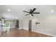 Open-concept living area with hardwood floors features a modern ceiling fan and seamless flow into the kitchen at 321 E Taylor St, Landis, NC 28088