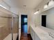 Bathroom featuring a double vanity, a glass-enclosed shower, and modern fixtures at 3629 Cerelia Ln, Denver, NC 28037