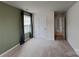 Bright bedroom featuring carpet flooring, a window with curtains, and a closet door at 3629 Cerelia Ln, Denver, NC 28037