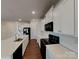 Bright kitchen with white cabinets, black appliances, and a spacious center island at 3629 Cerelia Ln, Denver, NC 28037