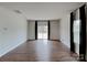 Spacious living room with wood flooring, a sliding glass door, and large windows at 3629 Cerelia Ln, Denver, NC 28037