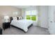 Bright bedroom with large windows, neutral wall colors, and plush carpeting for a cozy feel at 3735 Coleman Dr, Charlotte, NC 28215