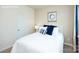 Bright bedroom featuring a cozy bed with blue accents and a neutral color scheme at 3735 Coleman Dr, Charlotte, NC 28215