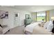 Serene bedroom featuring a neutral color scheme, dresser, a window and a doorway to the bathroom at 3735 Coleman Dr, Charlotte, NC 28215