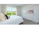Bright bedroom with large windows that offer a serene view of the outdoors and plush carpeting at 3735 Coleman Dr, Charlotte, NC 28215