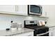 Close-up of a modern kitchen featuring stainless steel appliances and granite countertops at 3735 Coleman Dr, Charlotte, NC 28215