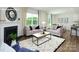 Bright living room featuring a fireplace, comfortable sofas, and a view into the dining area at 3735 Coleman Dr, Charlotte, NC 28215