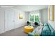 Comfortable living room with a desk area, blue sofa, bright yellow ottoman, and neutral walls at 3735 Coleman Dr, Charlotte, NC 28215