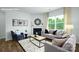 Cozy living room with a fireplace, comfortable seating and abundant natural light at 3735 Coleman Dr, Charlotte, NC 28215