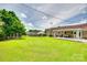 Expansive backyard featuring lush green grass, mature trees, and a cozy outdoor patio area at 3903 Graywood Dr, Gastonia, NC 28052