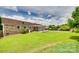 Lovely backyard with a covered patio, a well-manicured lawn, and vibrant landscaping at 3903 Graywood Dr, Gastonia, NC 28052