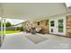 Inviting covered patio space with stylish seating, brick accents, and cozy ambiance at 3903 Graywood Dr, Gastonia, NC 28052